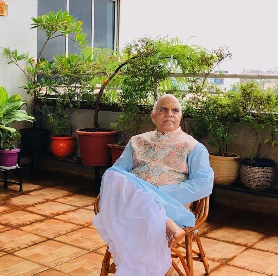 Dr. Radha Nand Singh seated on a terrace